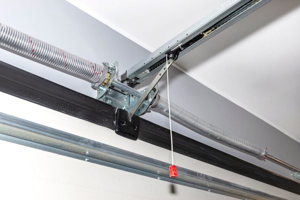 Springs tensioning the home garage door mechanism, visible disconnection of the electric drive and and spring protection.